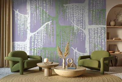 Living room with green chairs, a coffee table, and decorative items against a wall with tree mural -  willow tree wallpaper